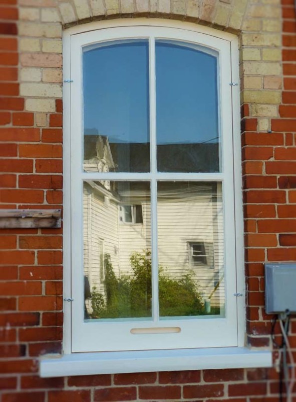 Double hung wooden window with new storm sash